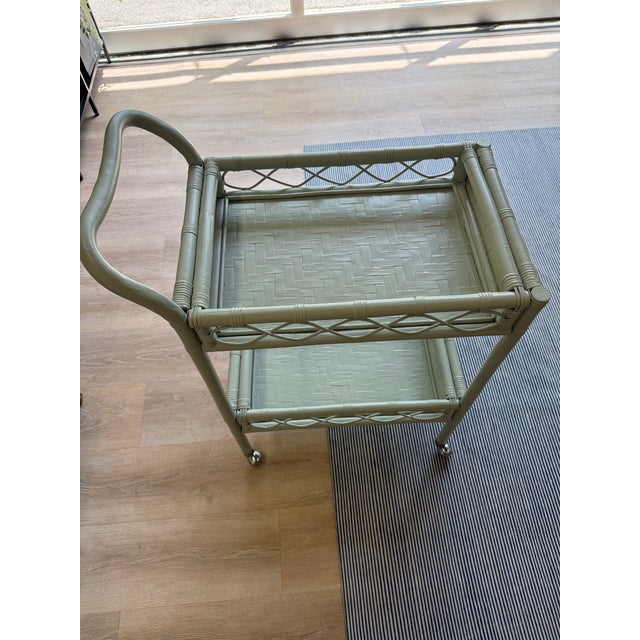 A one-of-a-kind vintage rattan bar cart, professionally refinished in a soft sage green for a collected, timeless look....