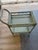 A one-of-a-kind vintage rattan bar cart, professionally refinished in a soft sage green for a collected, timeless look....