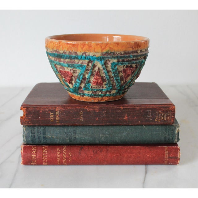 Vintage Italian pottery bowl featuring a textured "fat lava" style glaze and geometric patterns. Marked "Made in Italy" on...