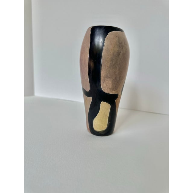 This striking stone vase combines beautiful craftsmanship with bold design. Hand-carved and stained, the piece features a...