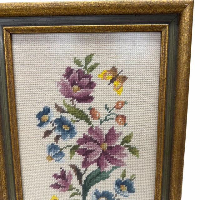 Vintage needlepoint floral and butterflies framed art. Frame has a green center with gild bands on each side. Frame...