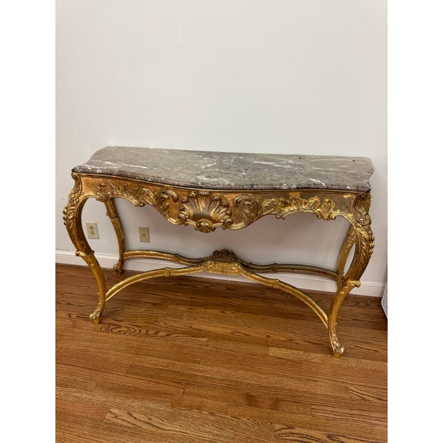 Console Gilded Wood and Marble Louis XV Style, carved and gilded console in a Venetian gold with red under tone in spots...