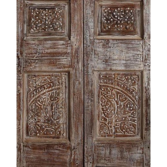 Elevate your interior with these antique carved wood doors featuring bold nail stud detailing and rich hand-carved...
