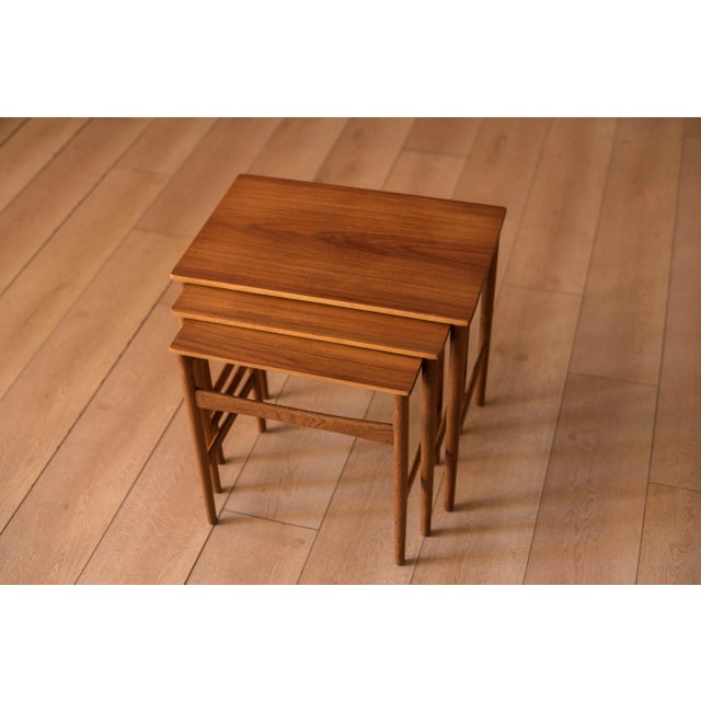 Mid-Century Modern set of three nesting tables in teak designed by Hans Wegner for Andreas Tuck, Denmark circa 1960's....