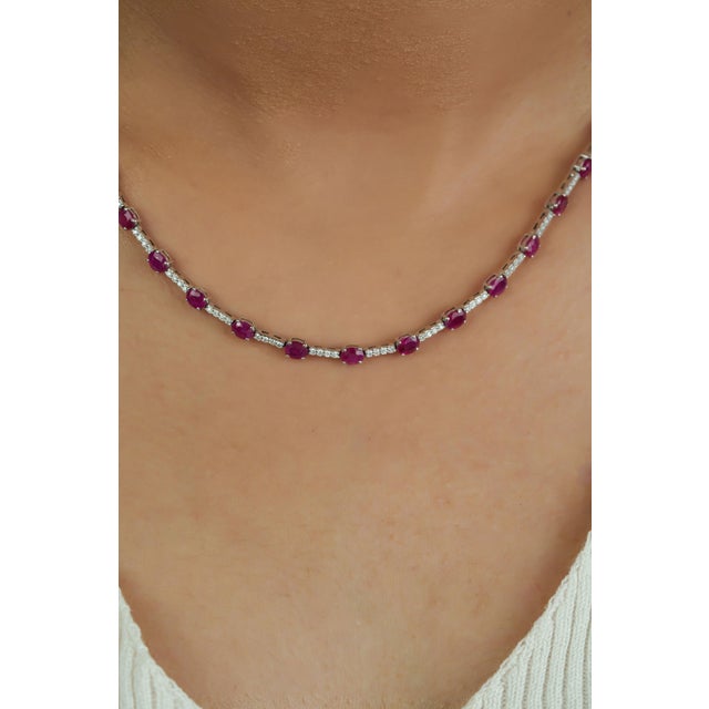 This contemporary Riviera tennis necklace showcases a 8.9 carats of rubies set in 14K white gold. The oval rubies,...