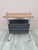 An elegant, mobile side table with a magazine rack, designed in the modernist style characteristic of the 1970s. The...