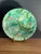 Barbotine majolica plate molded in relief with two birds on leafy branches among pink blossoms, within a molded wave-...