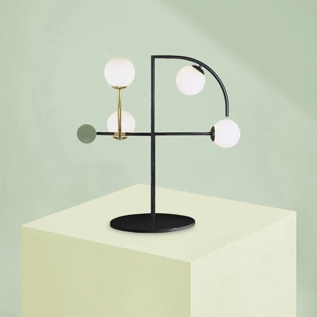 HELIO Table lamp This piece comes in multiple configurations and finishes. Up to 250V (Europe/UK Standard). Up to 250V...