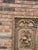 Hand-carved solid wood wall panel depicting a whimsical fruit motif in deep relief, framed by an architectural border. The...