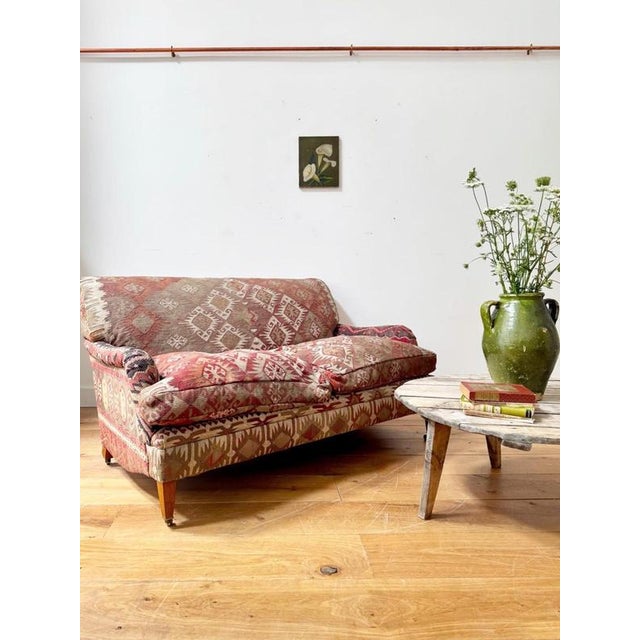 A stunning antique kilim covered two seater sofa with delightfully comfy proportions. Love the patterns, especially the...