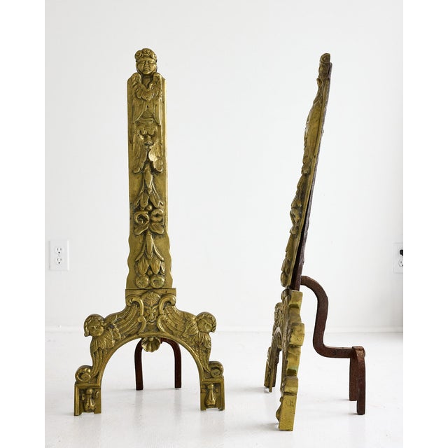 Pair of French Baroque Revival Gilt Bronze Figural Andirons with Winged Cherub Motifs. An exceptional pair of ornate gilt...