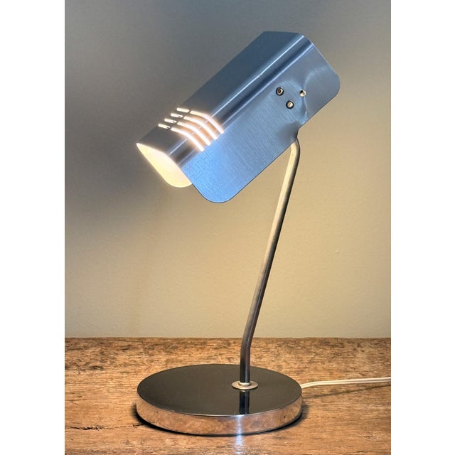 This Mid Century Modern Italian chrome table lamp was designed by Gino Sarfatti for Targetti Sankey and features a...