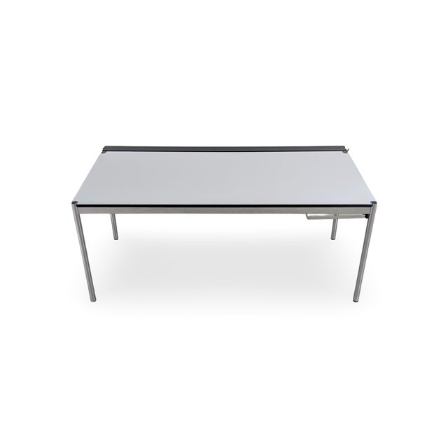 One of two beautiful USM Haller tables with a pearl gray tabletop and integrated cable management. The tables feature...