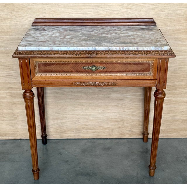 Beautiful pair of French nightstands from the 40s, made of wood. They have a small drawer on the front that is delicately...