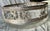 This is a clear glass bowl that is decorated in silver with alternating images of a laurel wreath with a long bow,...