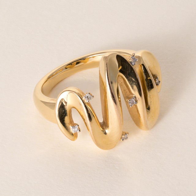 Vintage Diamond Wave Cocktail Ring in Yellow Gold This vintage cocktail ring showcases a beautifully fluid wave design,...