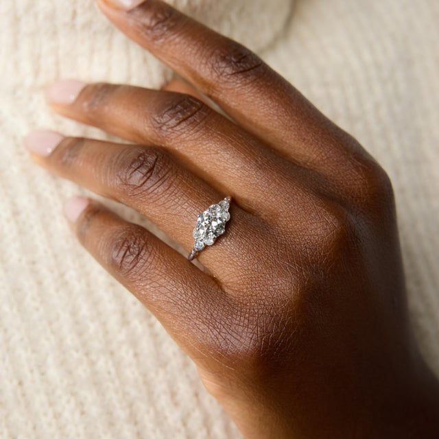 A graceful engagement ring from the Art Deco period, this elegant platinum design centers on a beautiful 1.38 carat old...