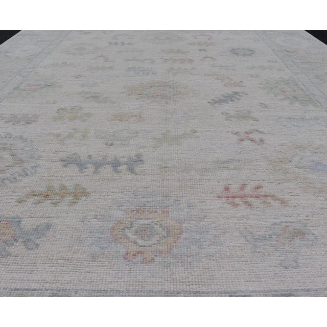 Large Oushak Rug with Floral Motifs & Muted Colorful Tones on Neutral Background. Keivan Woven Arts; rug AWR-17881 Country...