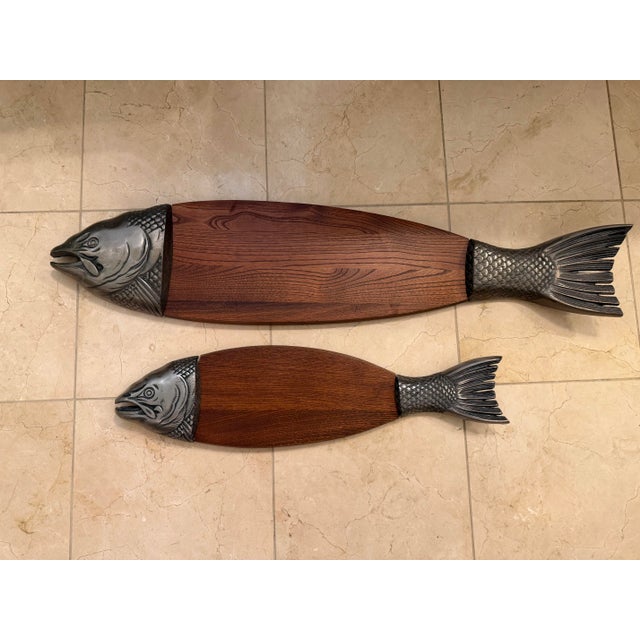 Cast metal fish forms mounted to solid wood panels. Sculptural lodge and lake-house decor with great scale and patina....