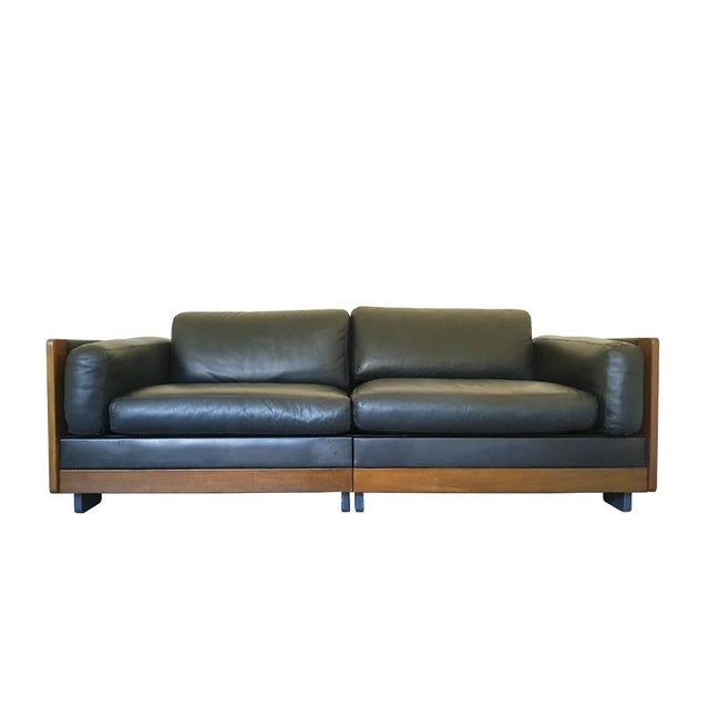 Pair of modular sofas in black leather and walnut designed by Afra and Tobia Scarpa and produced by Cassina since 1967....