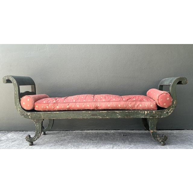 This exquisite antique settee is a masterclass in Neoclassical design, featuring a graceful scroll-arm silhouette...