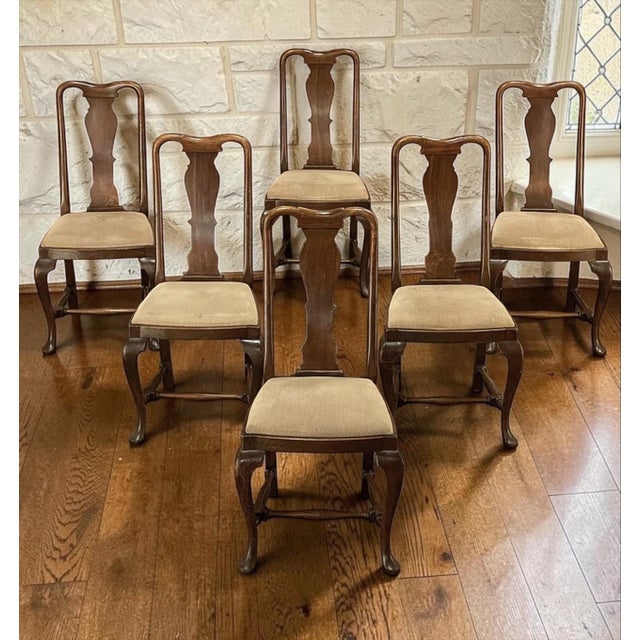This Set of 6 Antique Queen Anne Chestnut Dining Chairs offers a wonderful balance of refinement, warmth, and...