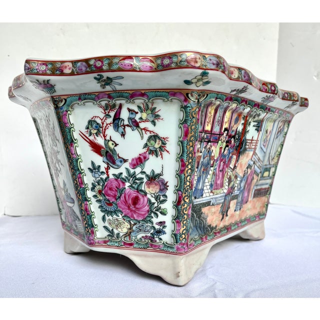 Chinese hexagonal porcelain planter. Each side has colorful Chinese figural scenes. The scalloped crown is also decorated...