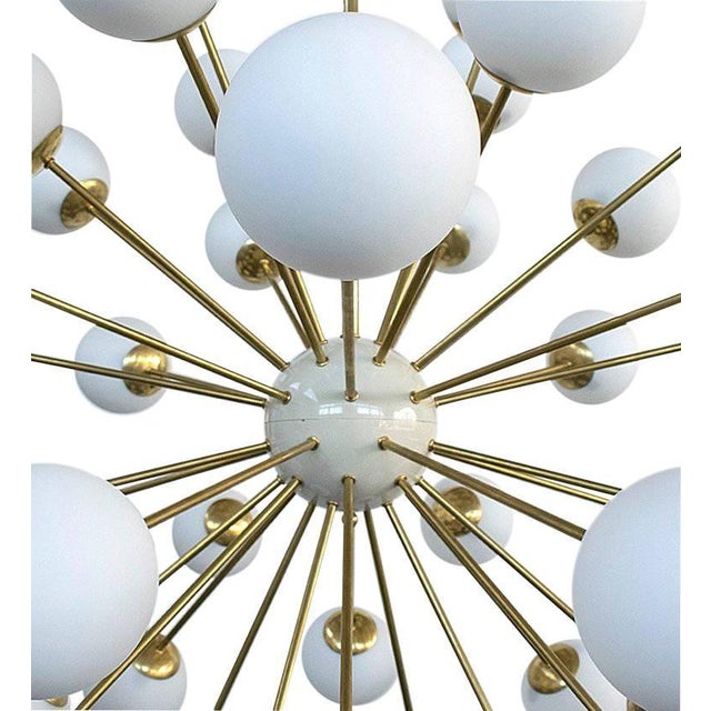 Italian sputnik chandelier with 40 matte white Murano glass globes mounted on brass frame in lacquered polished brass...