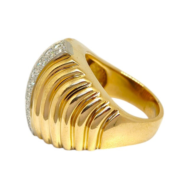 Circa 1960's DANKNER 14K gold ring, featuring a contemporary design with a ribbed yellow gold dome. A central band of...