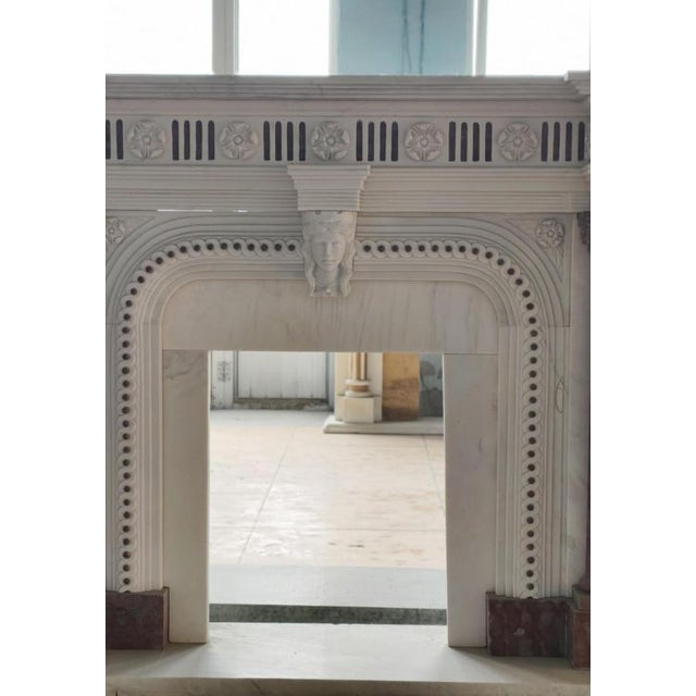 A stunning showcase of neoclassical grandeur, this finely carved marble fireplace mantle features a sophisticated blend of...