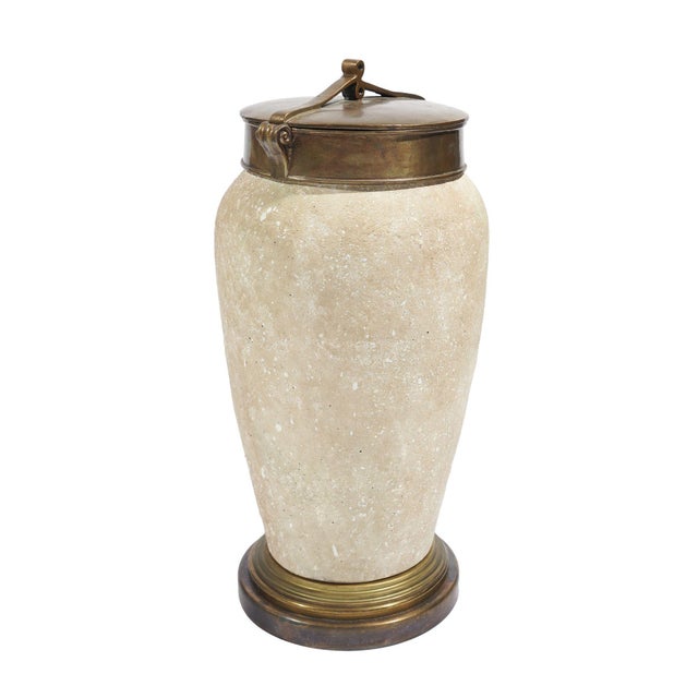 A high shouldered art pottery urn with a tapered body in travertine tan with a textured surface. The urn is fitted with a...