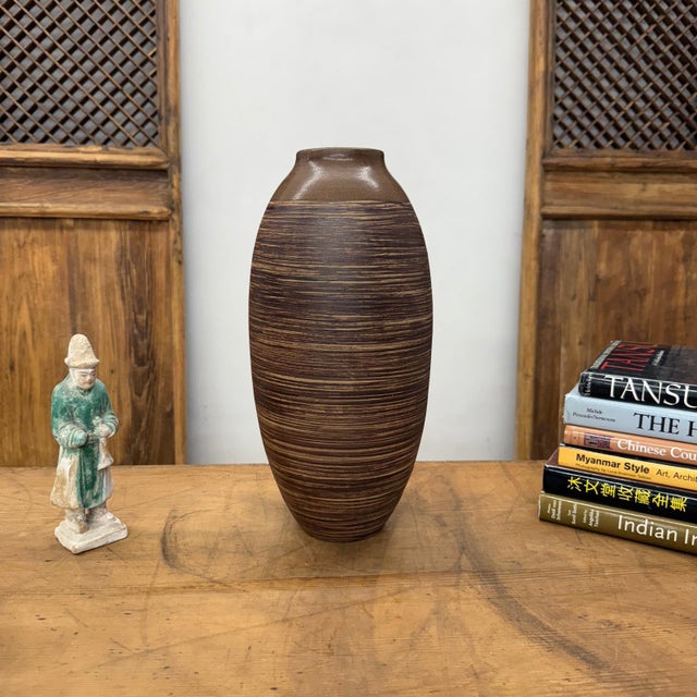 "About This Piece About This Piece Bring warmth and timeless style into your home with this elegant ceramic vase. Its rich...