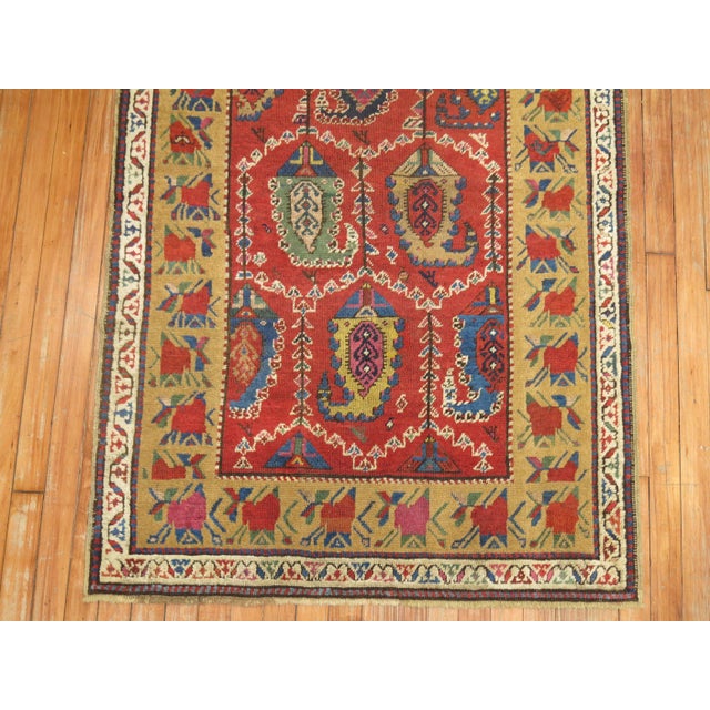 An early 20th century Caucasian Karabagh runner featuring a traditional paisley motif and floral border Measures: 3'4" x...