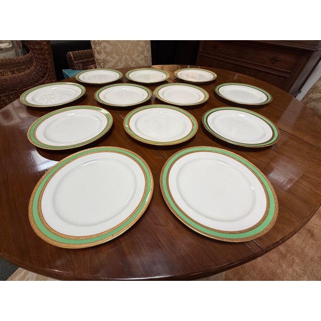 Design Plus Gallery presents a Set of Twelve English Pottery Plates, Stamped by Mintons. The plates have three rings of...