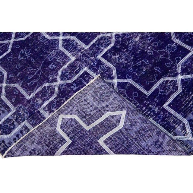 Beautiful Turkish handmade wool rug with a blue distress look field. This Modern rug has white accents featuring a...