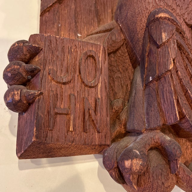 Mid-century carved wooden wall plaque depicting the Eagle of St. John, book in talon.