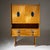 Credenza with a two-door upper section and four drawers, raised on slender legs. The drawer pulls are made of blue-and-...