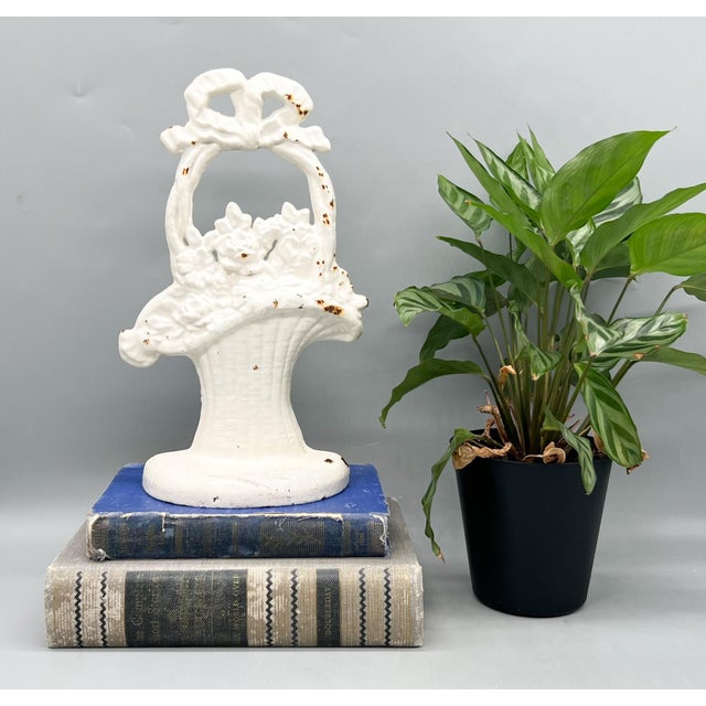 Delightful vintage white cast floral door stop featuring a dimensional basket overflowing with blooms and topped with a...