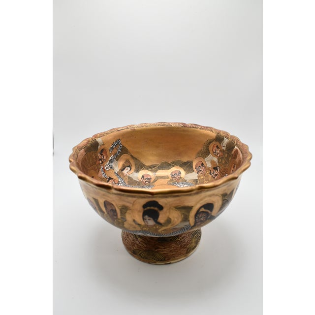 This is a Japanese Satsuma pedestal bowl. It is from the Meiji period (1868-1912). It depicts a white dragon and monks and...