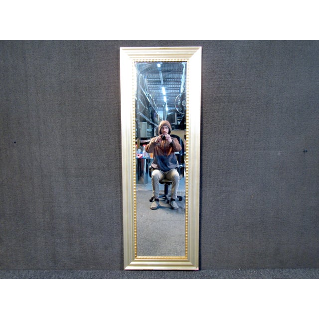 This elegant mid-century style mirror features a sloped silver frame with ribbed accenting. A perfect addition to narrow...