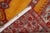 An early 20th century angora wool Oushak rug with a bright saffron color field with a double scroll column prayer motif....