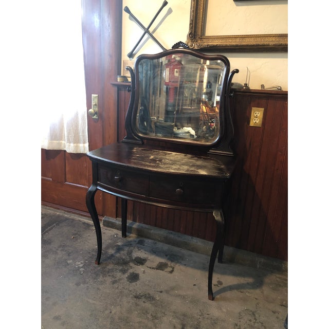 Dark stain classic antique vanity. Has a beautiful profile. Simple and smooth design elements. Original beveled mirror set...