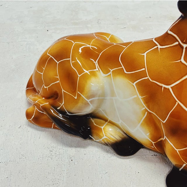 Unique handmade statue of a giraffe. This Hollywood Regency statue, crafted from hand-painted ceramic and made in Italy,...