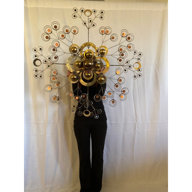 A very rare Cutis Jere Sun Drop Wall Sculpture. Featuring radiating arms in satin brass, patina torched and copper toned...