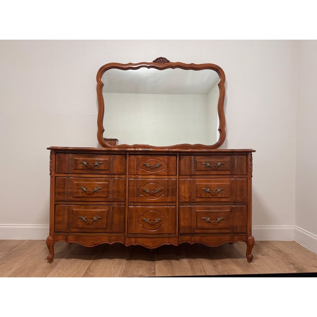 An elegant dresser with coordinating mirror likely by Broyhill or Caldwell, dating to circa 1960s. The only marking we...