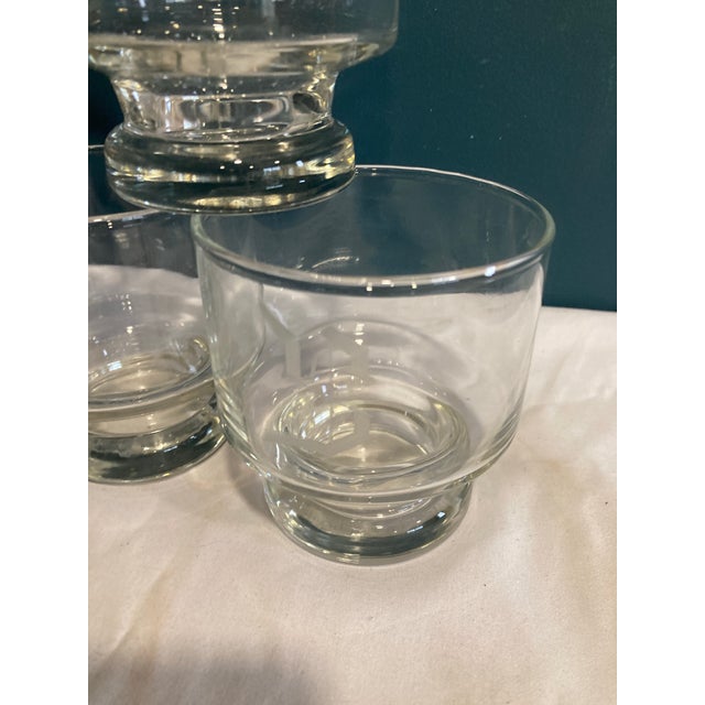A nice set of 8 double old fashioned lowball glasses etched with an "S." They have nice footed bottoms and are in...