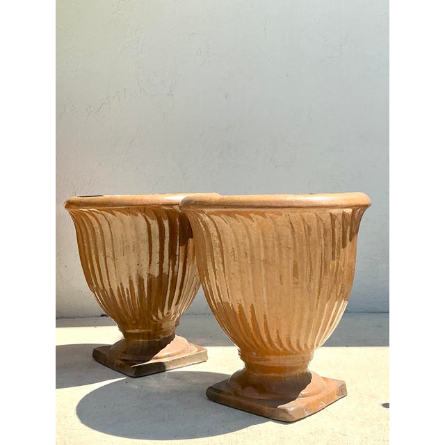 Elevate your garden or grand entryway with this striking pair of vintage glazed terracotta planters. Each urn features a...