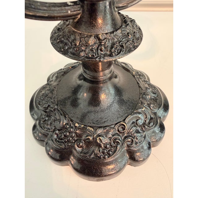 Distinctive vintage two-arm candelabrum crafted of brass with a dramatic black powder-coated finish. Ornate raised grape,...