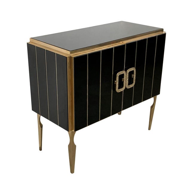 Sideboard with two doors, entirely handmade, with wooden structure and surface finishes in black Murano glass; profiles,...