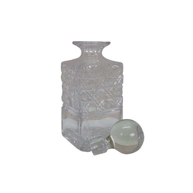 Mid to early century American cut crystal decanter with stopper. Dimensions: 3.25" x 3.25" x 8.75" (W x D x H)